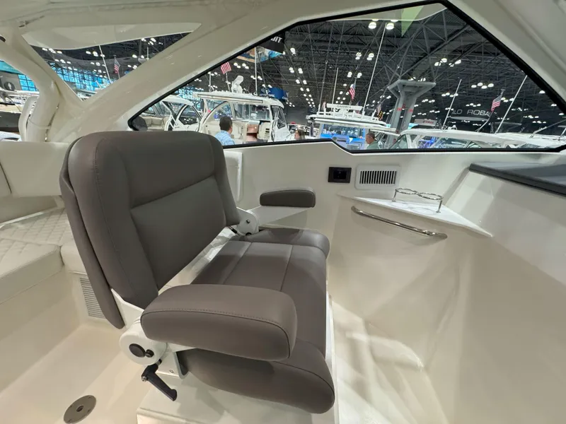 Slide: The Image of 2025 Pursuit OS 405 boat with triple outboard engines and seating area. - 15