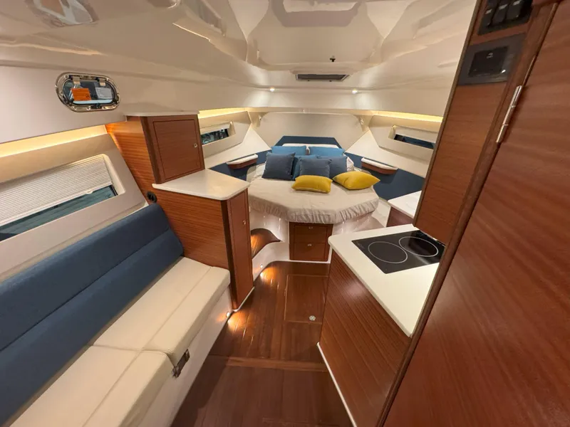 Slide: The Image of 2025 Pursuit OS 405 boat interior with seating and modern design at a boat show. - 22