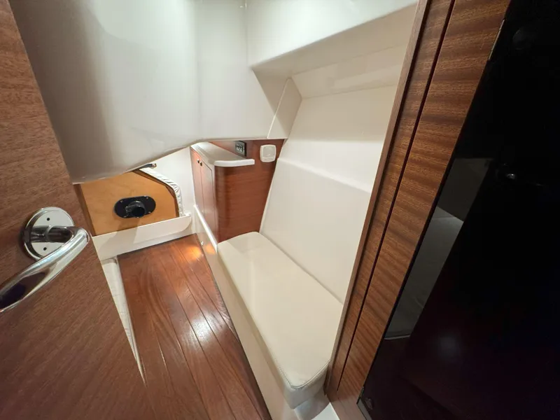 Slide: The Image of Captain's chair and helm of 2025 Pursuit OS 405 boat at a boat show. - 25