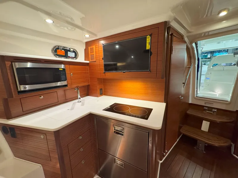 Slide: The Image of Luxurious bathroom interior of 2025 Pursuit OS 405 boat, featuring modern fixtures and wood accents. - 31