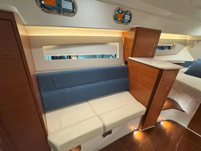 Slide: The Image of 2025 Pursuit OS 405 interior with modern seating and wood accents. - 35