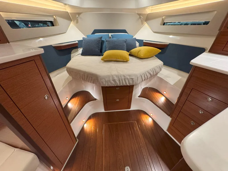 Slide: The Image of Luxurious cabin interior of 2025 Pursuit OS 405 yacht with elegant wood finish and cozy bedding. - 37