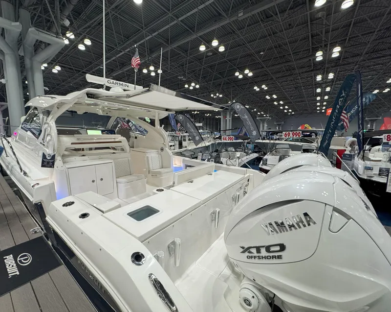 Slide: The Image of 2025 Pursuit OS 405 Offshore boat with triple engines on calm water. - 4