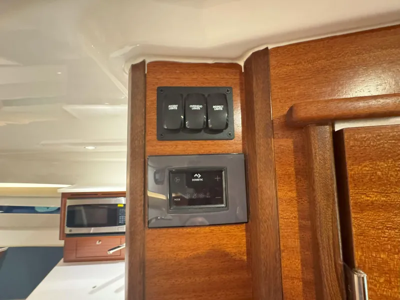 Slide: The Image of Control panel and switches inside 2025 Pursuit OS 405 boat cabin. - 42