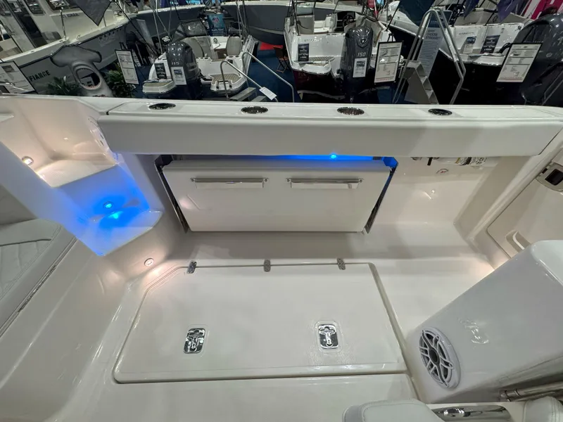 Slide: The Image of 2025 Pursuit OS 405 Offshore boat cruising on a serene lake with lush green shoreline. - 8