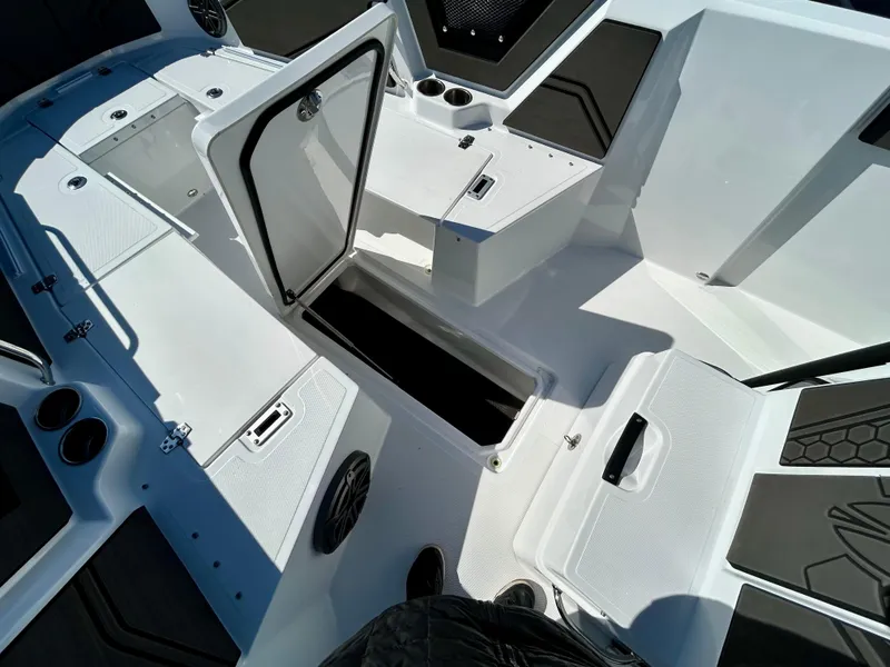 Slide: The Image of 2024 Scarab 255 Open boat interior with open storage compartments and seating. - 12