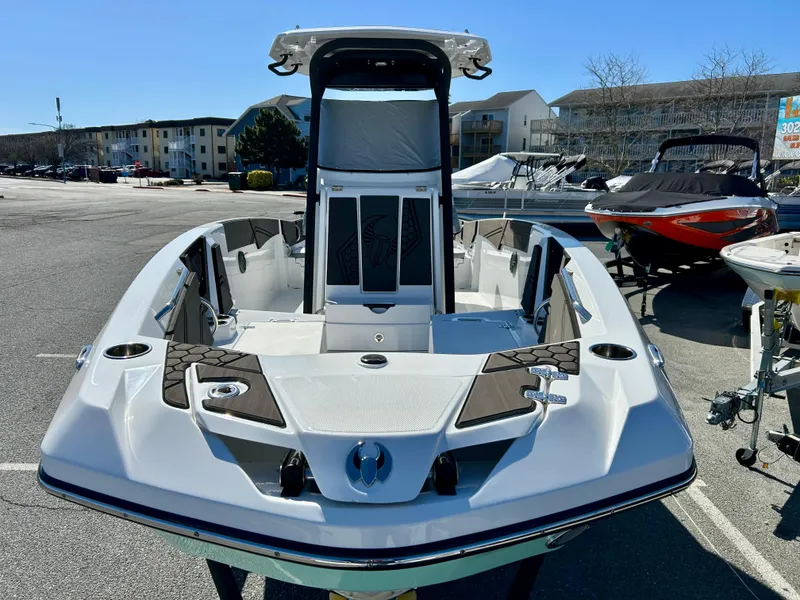 Slide: The Image of 2024 Scarab 255 Open boat, sleek design, parked outdoors in a marina setting. - 13