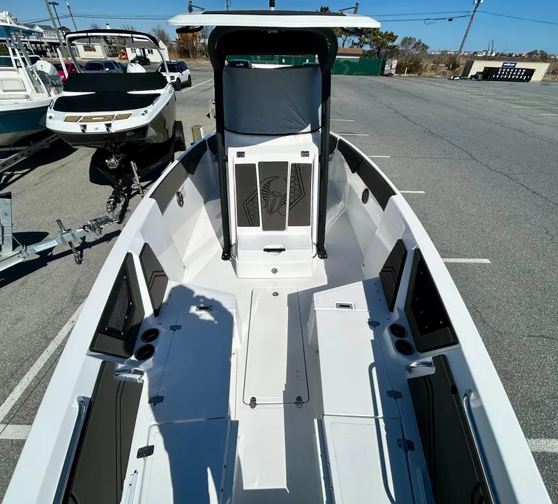 Slide: The Image of 2024 Scarab 255 Open boat, spacious deck, modern design, parked on a trailer. - 4
