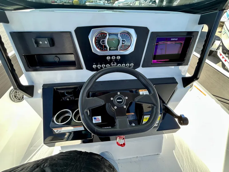 Slide: The Image of 2024 Scarab 255 Open boat dashboard with steering wheel and control panel. - 6
