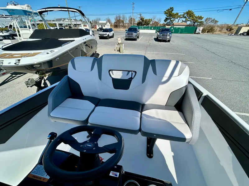 Slide: The Image of 2024 Scarab 255 Open boat interior with steering wheel and cushioned seating. - 7