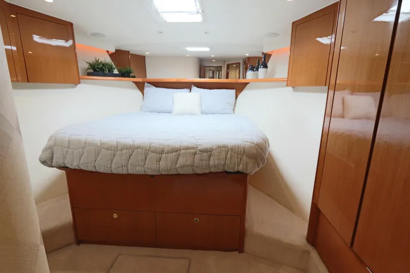 Slide: The Image of Luxurious cabin interior of 2000 Viking 65 yacht with cozy bed and wooden cabinetry. - 10