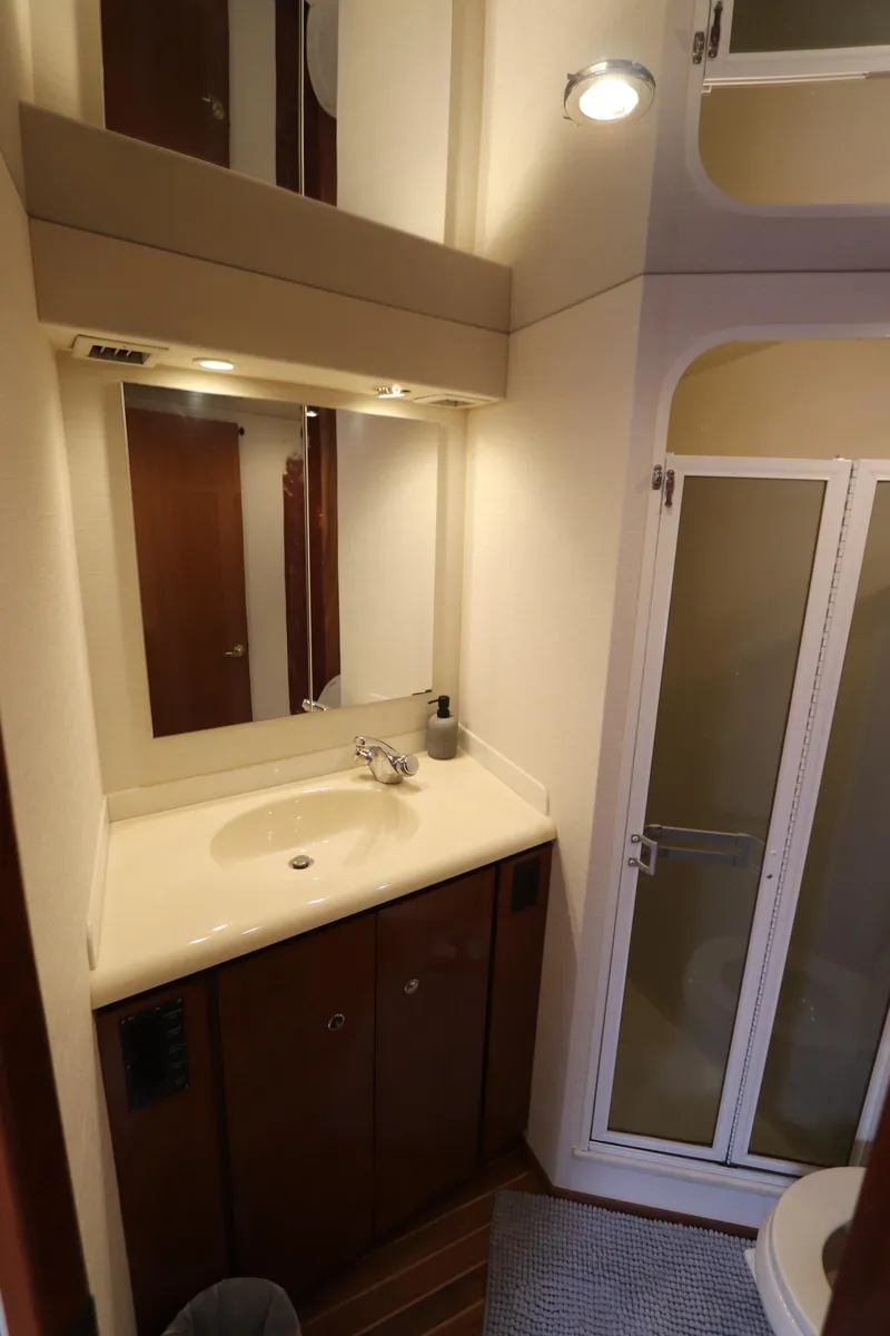 Slide: The Image of Bathroom interior of a 2000 Viking 65 yacht with sink and shower. - 11