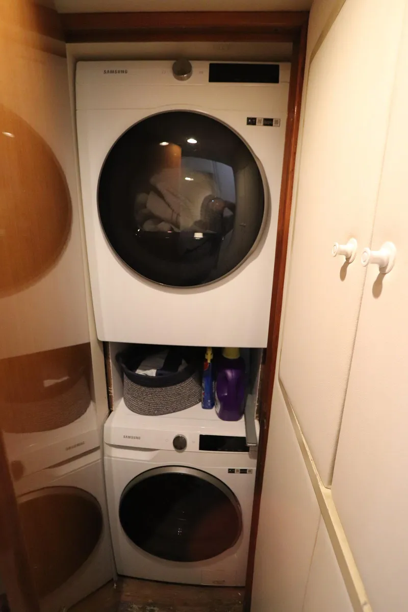 Slide: The Image of Stacked washer and dryer in compact laundry space on Viking 65 yacht, 2000 model. - 16