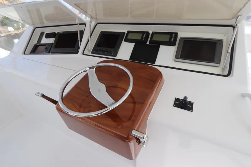 Slide: The Image of Steering wheel and dashboard of a 2000 Viking 65 yacht with navigation instruments. - 17