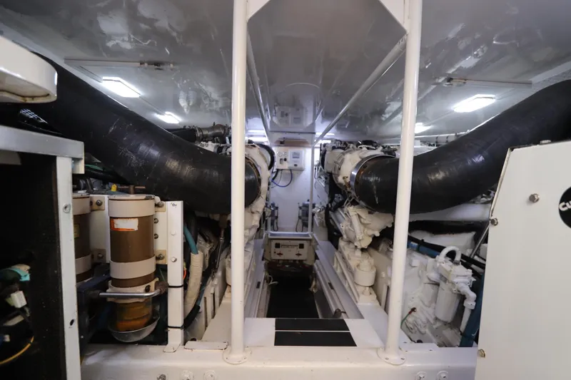 Slide: The Image of Engine room of a 2000 Viking 65 yacht, showcasing dual engines and mechanical components. - 20