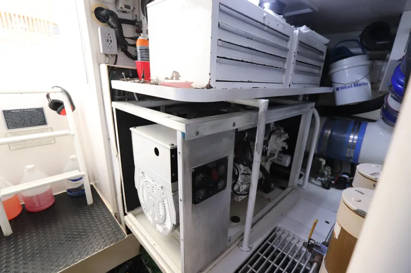 Slide: The Image of Engine room of a 2000 Viking 65 yacht, featuring equipment and storage. - 22