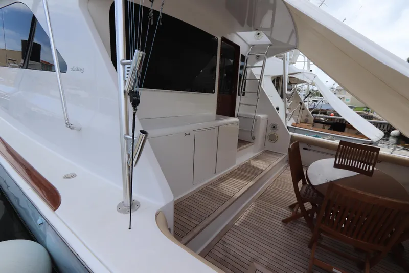 Slide: The Image of Luxury Viking 65 yacht deck with seating, 2000 model, featuring elegant wood finishes. - 28