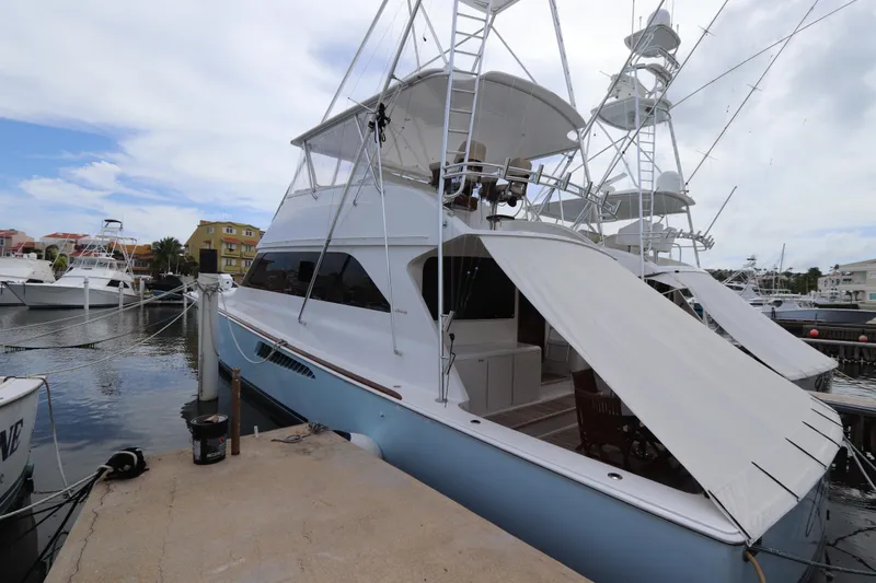 Slide: The Image of Luxury Viking 65 yacht docked at marina, 2000 model, with sleek design and spacious deck. - 29