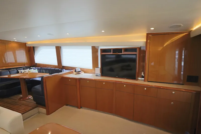 Slide: The Image of Luxurious interior of a 2000 Viking 65 yacht with wood cabinetry and seating area. - 3