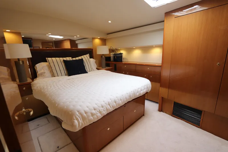Slide: The Image of Luxurious bedroom interior of a 2000 Viking 65 yacht with elegant wood finishes. - 7