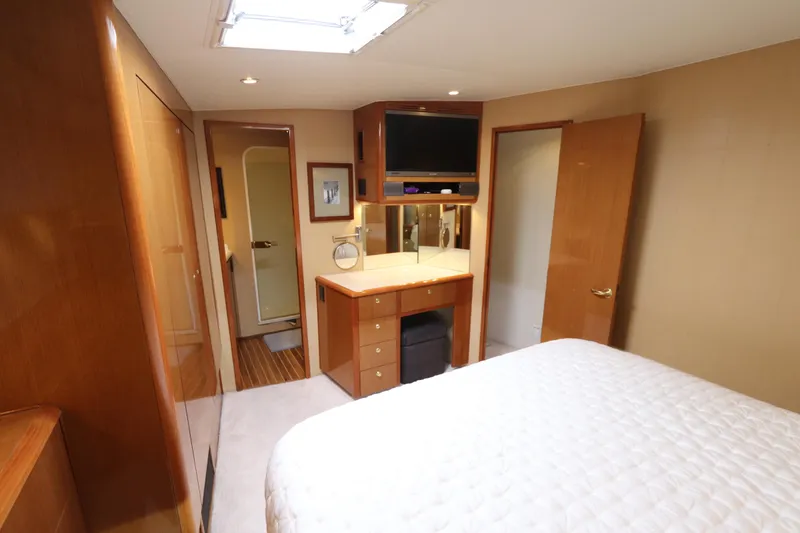Slide: The Image of Luxurious bedroom interior of a 2000 Viking 65 yacht with modern amenities. - 8