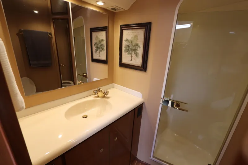 Slide: The Image of Bathroom interior of 2000 Viking 65 yacht with sink, mirror, and shower. - 9
