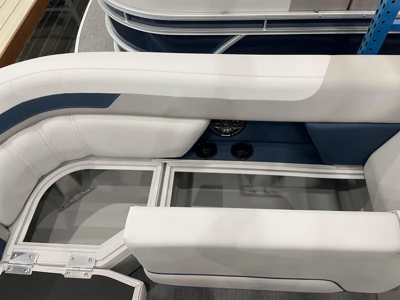 Slide: The Image of 2025 Godfrey Sweetwater 2086 C boat interior with white and blue seating and storage compartments. - 12