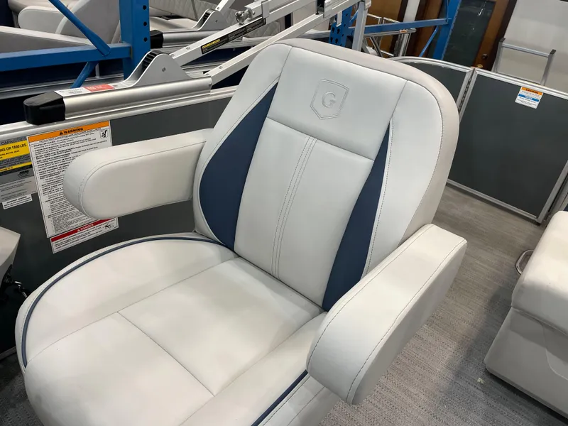 Slide: The Image of Luxurious seating on 2025 Godfrey Sweetwater 2086 C pontoon boat, featuring white and blue upholstery. - 6