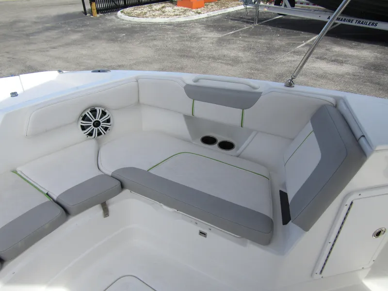 Slide: The Image of 2022 Tahoe 2150 CC boat interior with cushioned seating and speaker. - 11