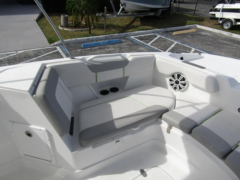 Slide: The Image of 2022 Tahoe 2150 CC boat interior with cushioned seating and speaker. - 12