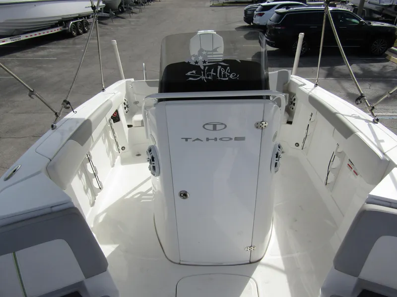 Slide: The Image of 2022 Tahoe 2150 CC boat interior with sleek white design and spacious seating. - 13