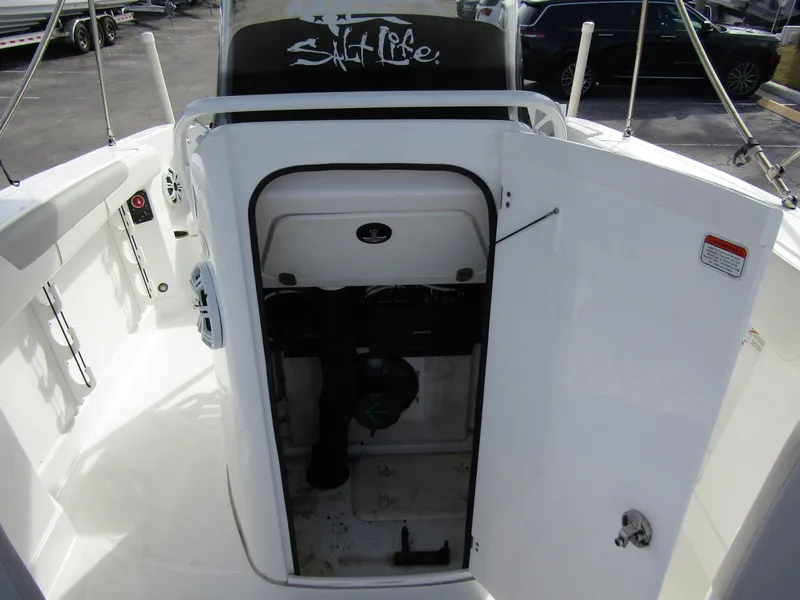 Slide: The Image of 2022 Tahoe 2150 CC boat interior with open storage compartment. - 14