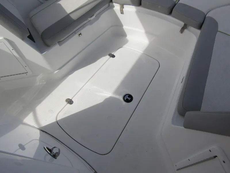 Slide: The Image of 2022 Tahoe 2150 CC boat interior with gray seating and storage compartment. - 15