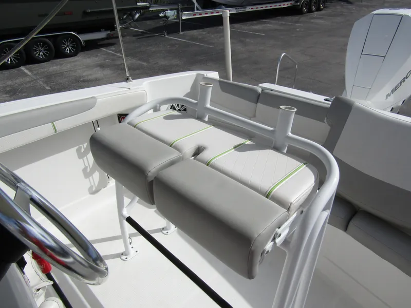 Slide: The Image of 2022 Tahoe 2150 CC boat interior with cushioned seating and steering wheel. - 19