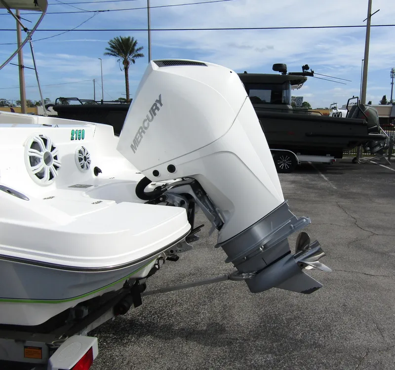 Slide: The Image of 2022 Tahoe 2150 CC boat with Mercury outboard motor in a parking lot. - 2