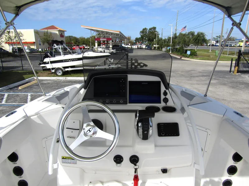 Slide: The Image of 2022 Tahoe 2150 CC boat dashboard with steering wheel and controls. - 20