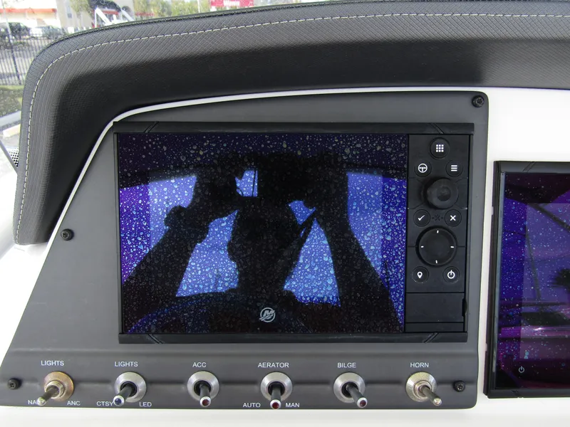 Slide: The Image of Dashboard of 2022 Tahoe 2150 CC boat with control panel and screen. - 21