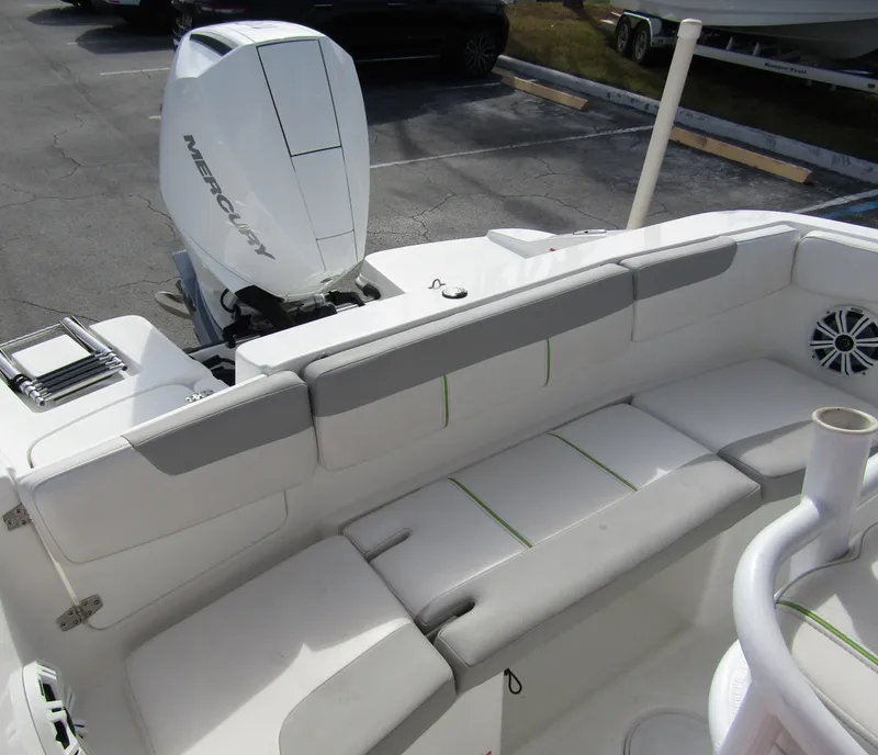Slide: The Image of 2022 Tahoe 2150 CC boat interior with Mercury engine, featuring white seating and modern design. - 26