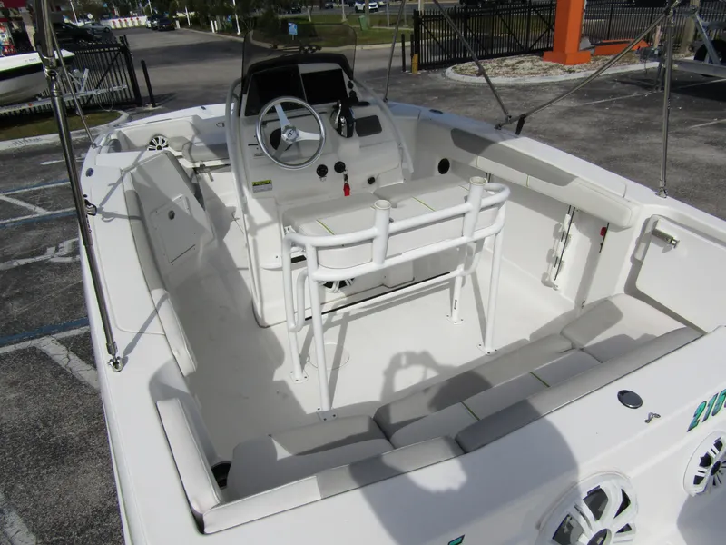 Slide: The Image of 2022 Tahoe 2150 CC boat interior with seating and steering console. - 31