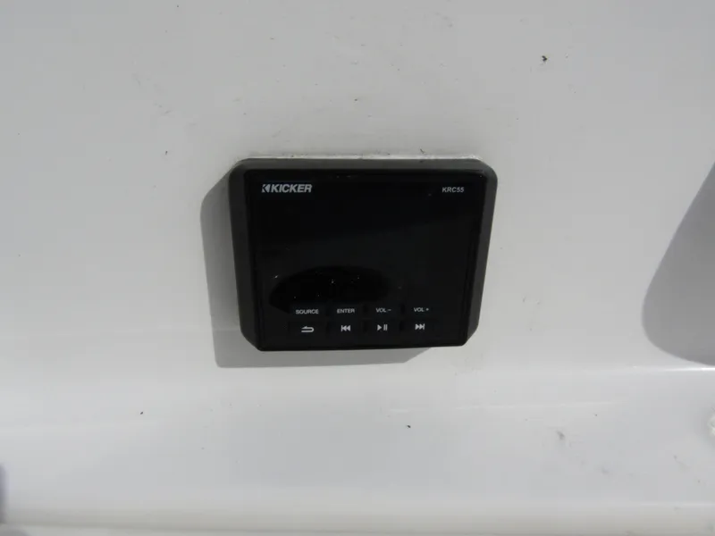 Slide: The Image of Kicker stereo system on 2022 Tahoe 2150 CC boat dashboard. - 32