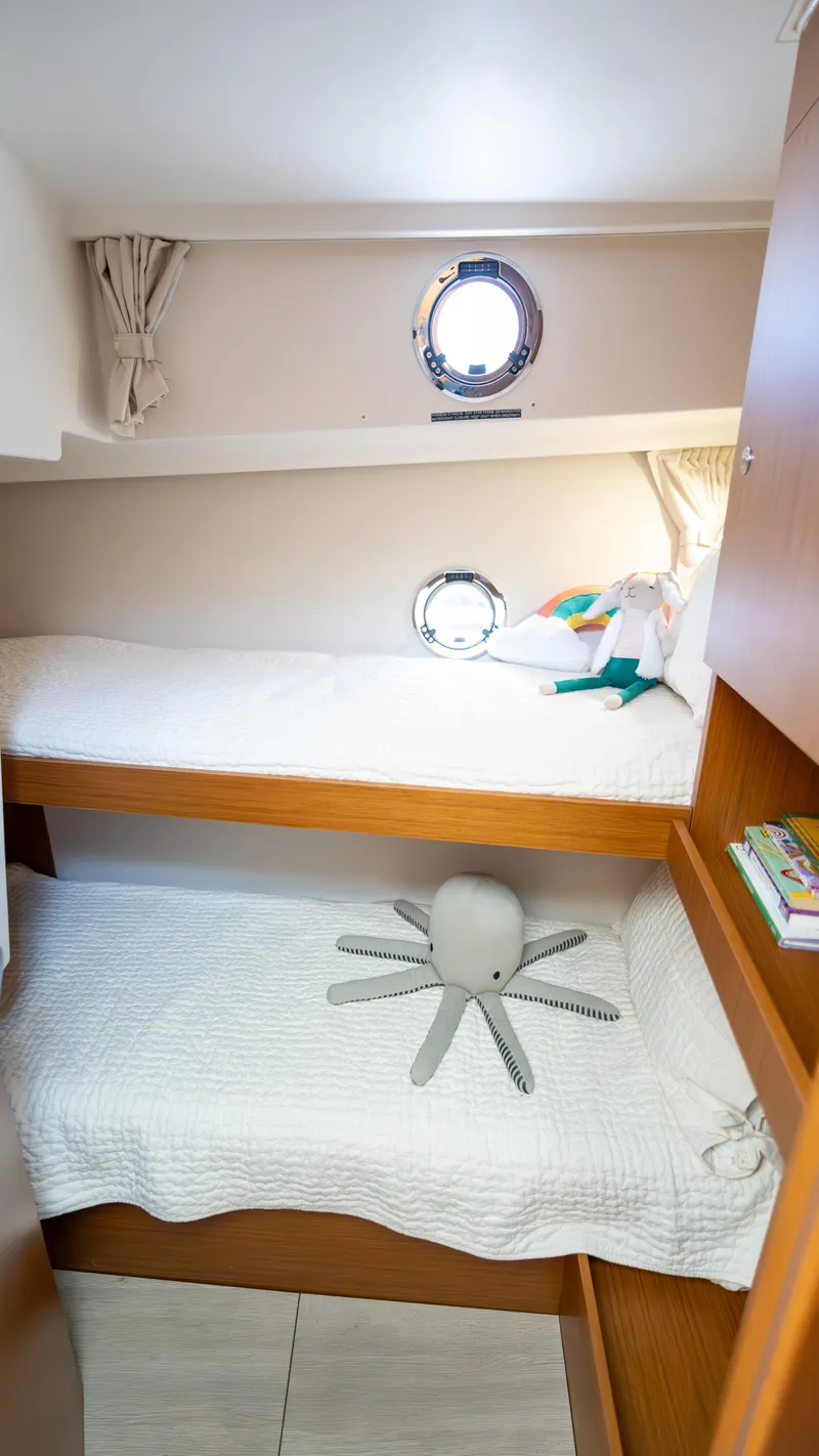 Slide: The Image of 2023 Beneteau Swift Trawler 35 cabin with bunk beds and nautical decor. - 14