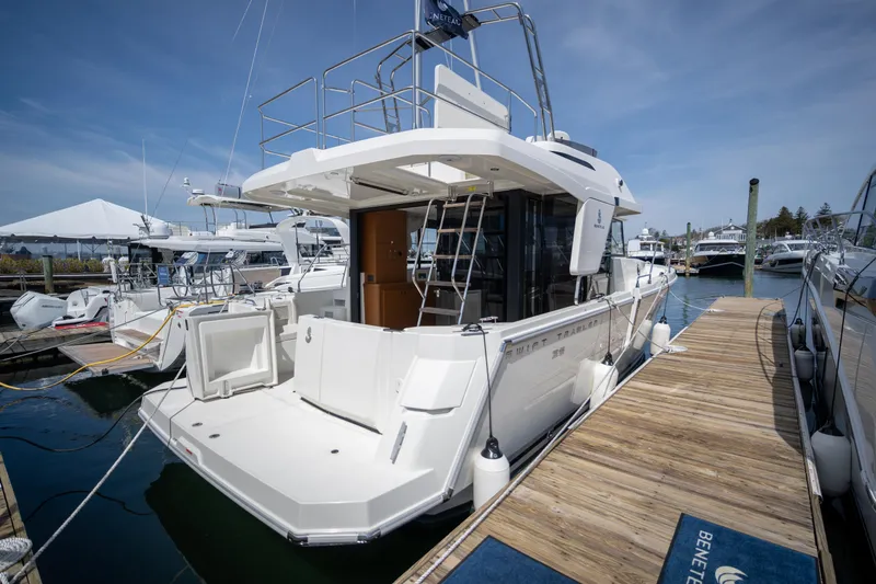 Slide: The Image of 2023 Beneteau Swift Trawler 35 docked, showcasing spacious deck and modern design. - 16