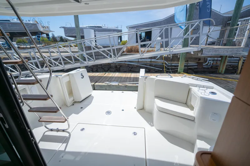 Slide: The Image of 2023 Beneteau Swift Trawler 35 deck with seating and dock view. - 18