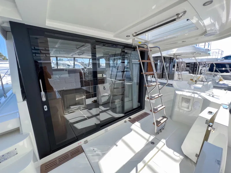 Slide: The Image of 2023 Beneteau Swift Trawler 35, spacious deck with modern design and sliding glass doors. - 19