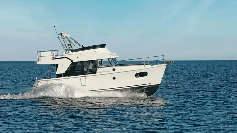 Slide: The Image of 2023 Beneteau Swift Trawler 35 cruising on open sea. - 21