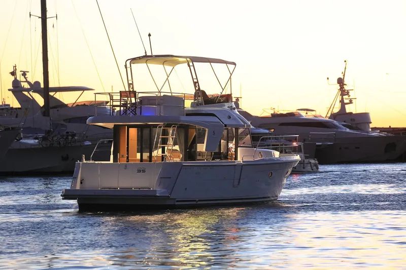 Slide: The Image of 2023 Beneteau Swift Trawler 35 at sunset in marina. - 24