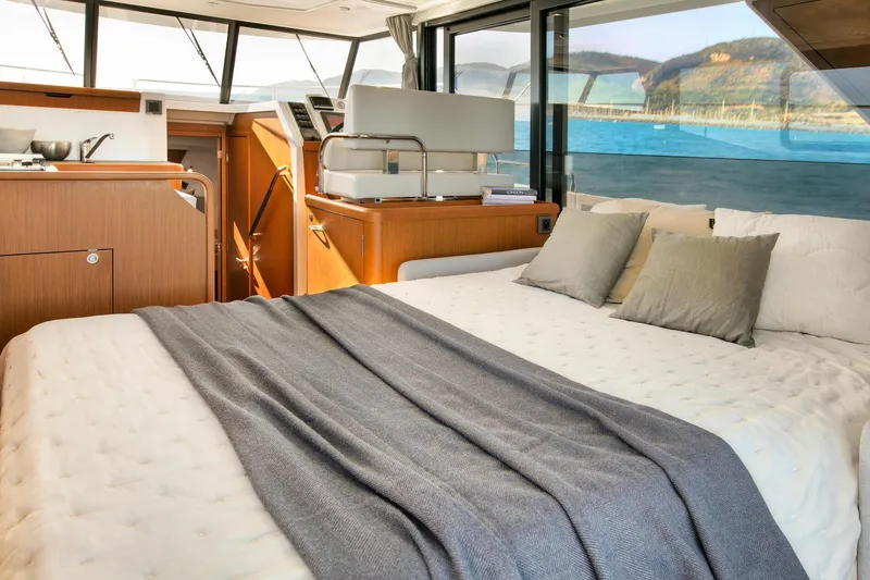Slide: The Image of Luxurious interior of 2023 Beneteau Swift Trawler 35, featuring a cozy bed and scenic views. - 4