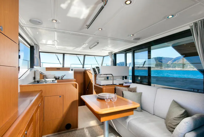 Slide: The Image of 2023 Beneteau Swift Trawler 35 interior with modern kitchen and seating area. - 5