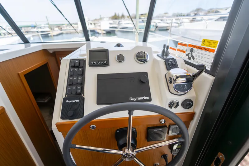 Slide: The Image of 2023 Beneteau Swift Trawler 35 helm with Raymarine navigation system. - 9