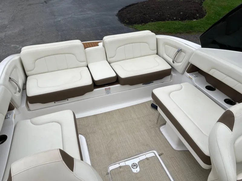 Slide: The Image of 2014 Chaparral 257 SSX boat interior with white and brown seating. - 11